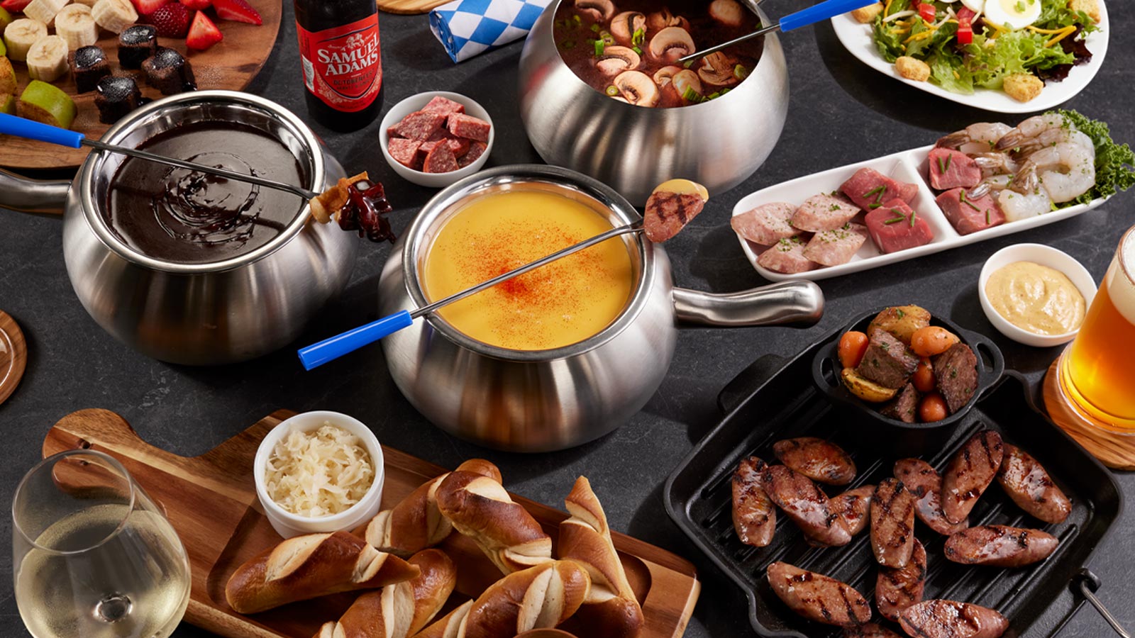 a table with food and a pot of fondue