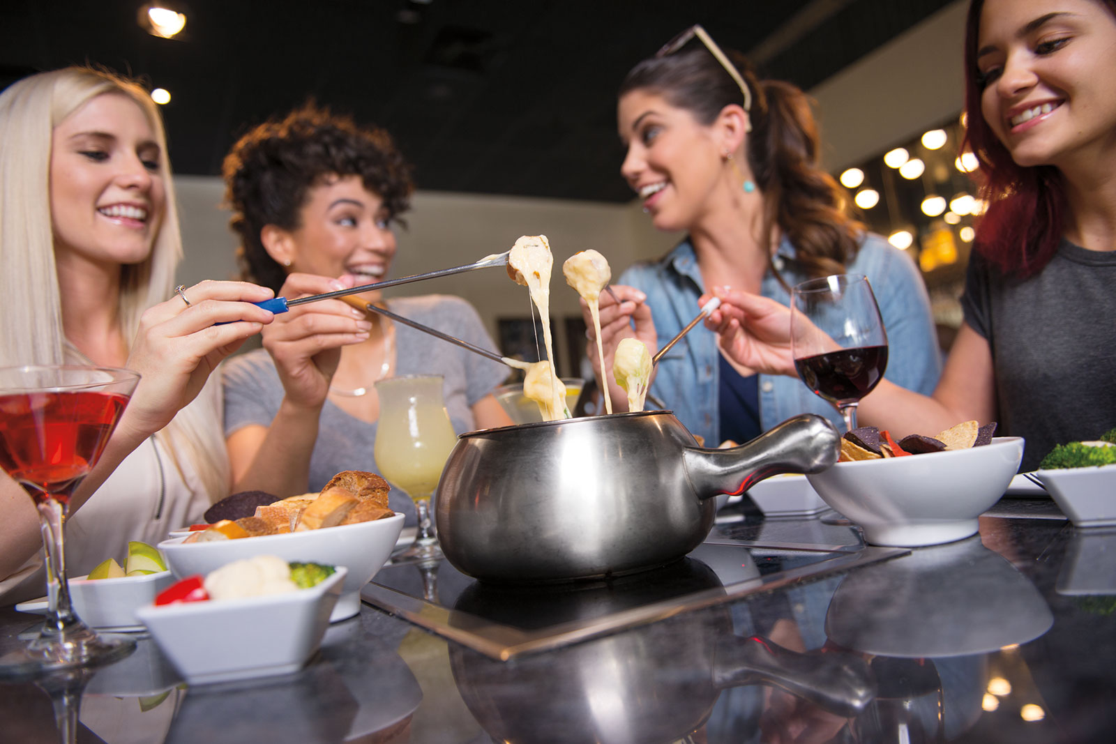 Three Women Having Fun at the Melting Pot Fondue Restaurant